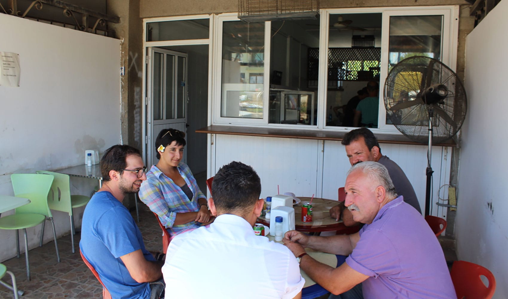 Antoniou and her team chat with locals at a restaurant