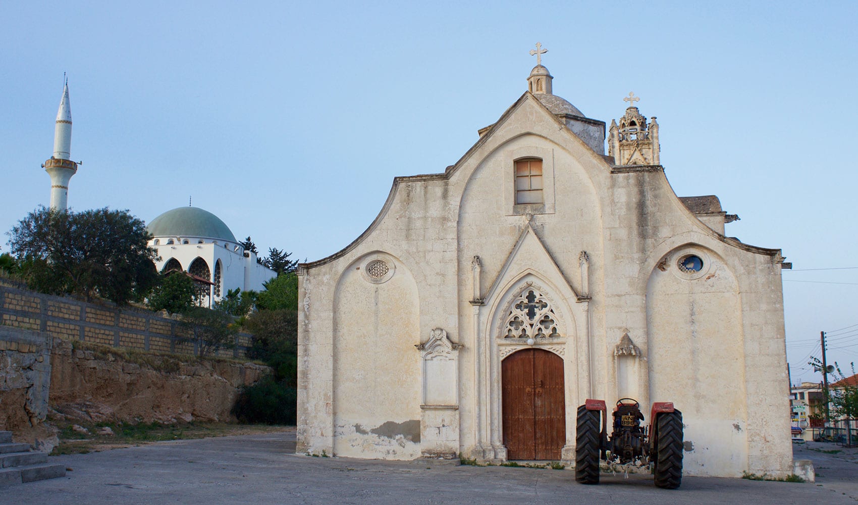 Greek Orthodox church sits near a Muslim mosque in the town of Rizokarpaso