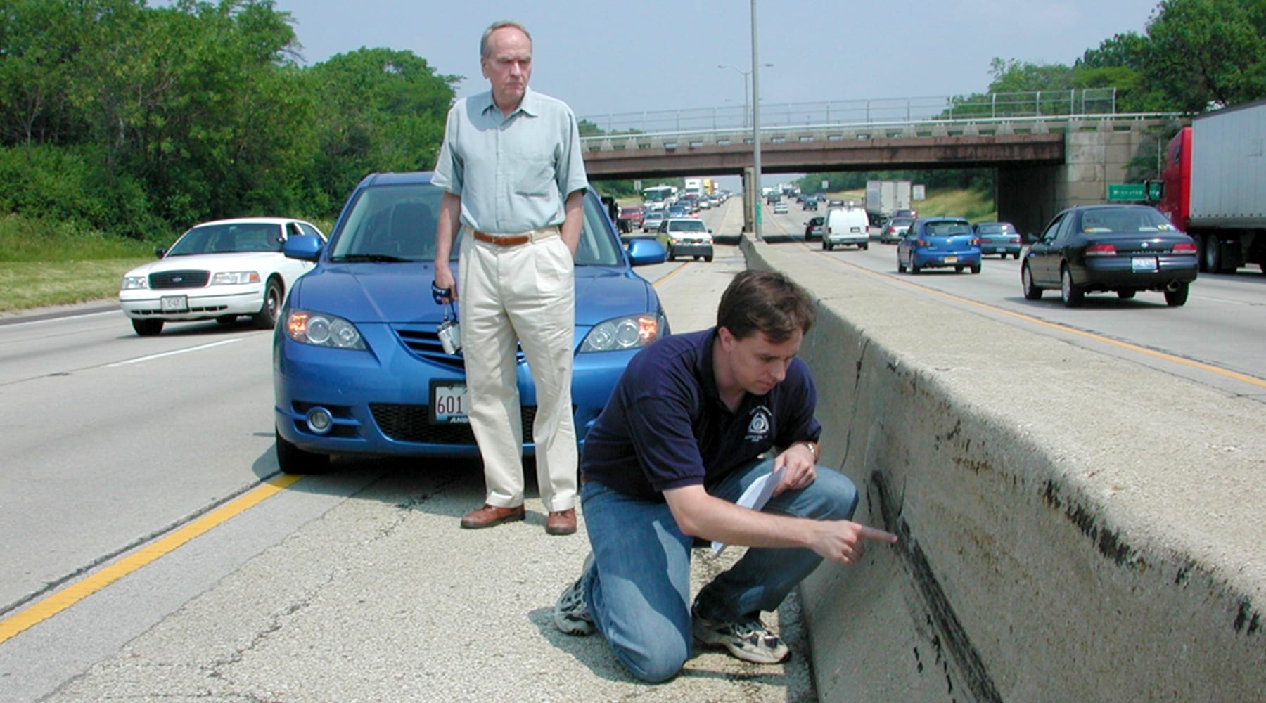 Palenik collecting samples from a car crash site