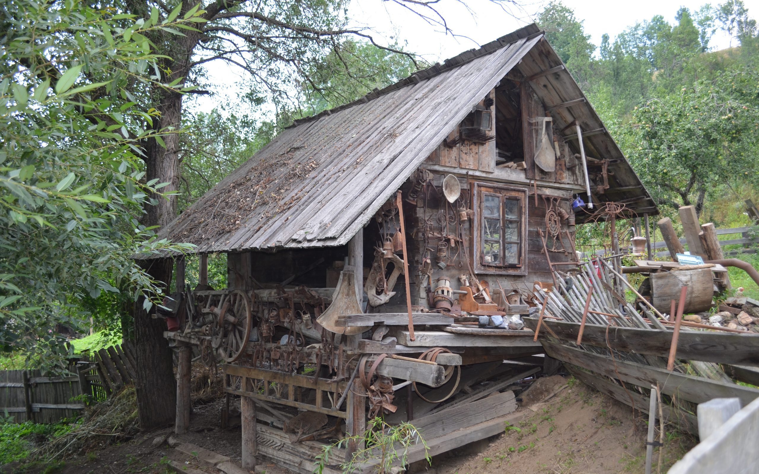 An old wooden building covered in mining tools.