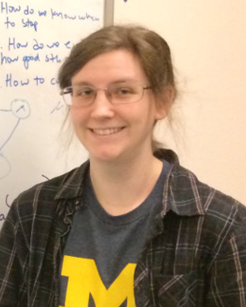 Jess Millar near the whiteboard in a lab.