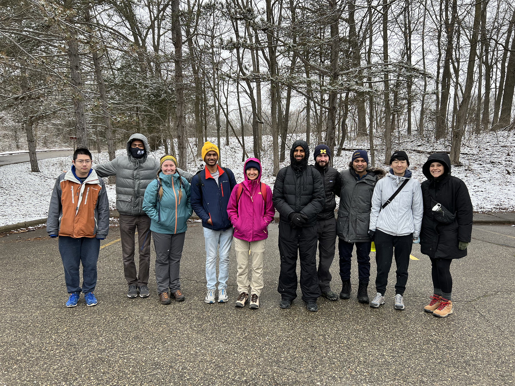 GRIN members stand in front of snowy trees.