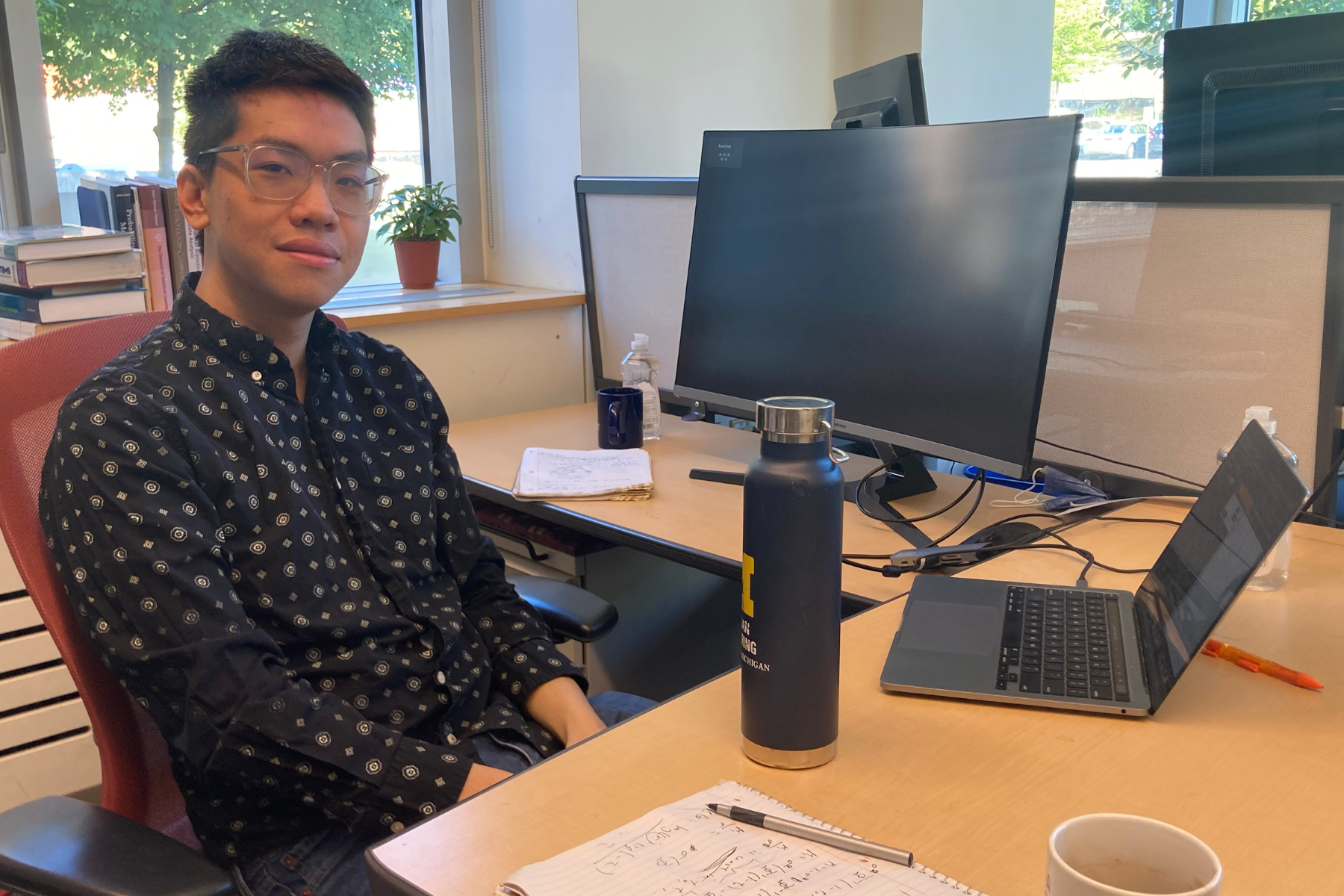 Trenton Chang sits at his desk, working on his laptop.