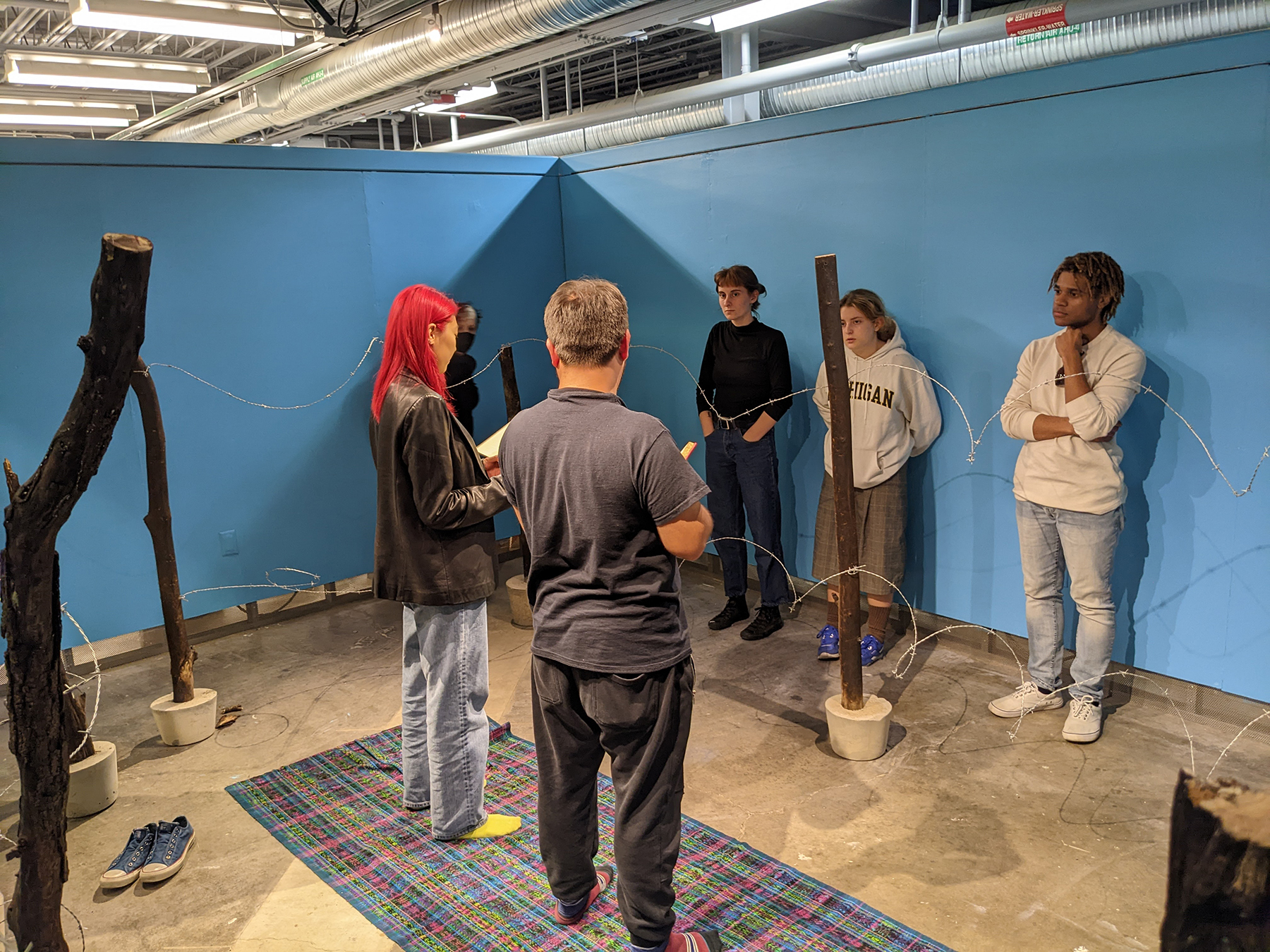 A group of five individuals standing around Granillo's work in progress.