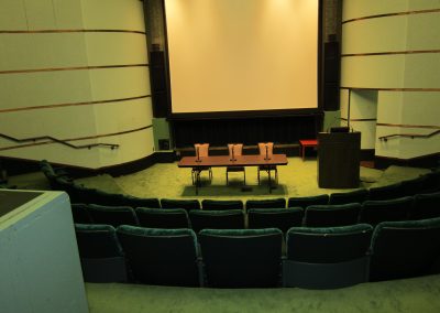 Rackham Amphitheatre. Panel table set up for three speakers.