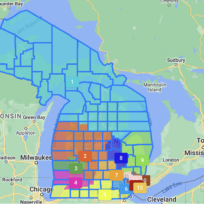 Map showing Michigan's voting districts in various colors, including labeled numbers 1 to 13, with a key on the right indicating corresponding colors for each district.