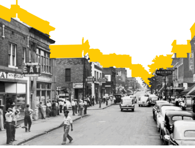 Black and white photo of a busy city street lined with parked cars and people walking on sidewalks; yellow is highlighted on the building tops and sky.