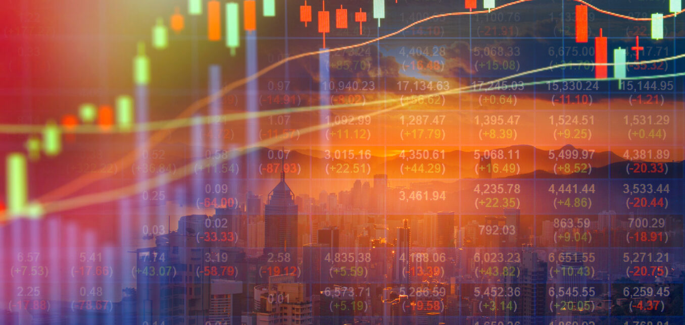 Candlestick stock chart and financial data overlaid on a city skyline with a sunset in the background, symbolizing global financial markets.