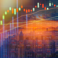 Candlestick stock chart and financial data overlaid on a city skyline with a sunset in the background, symbolizing global financial markets.