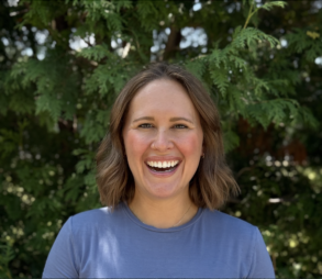 A headshot of Brianne Brenneman, smiling broadly.