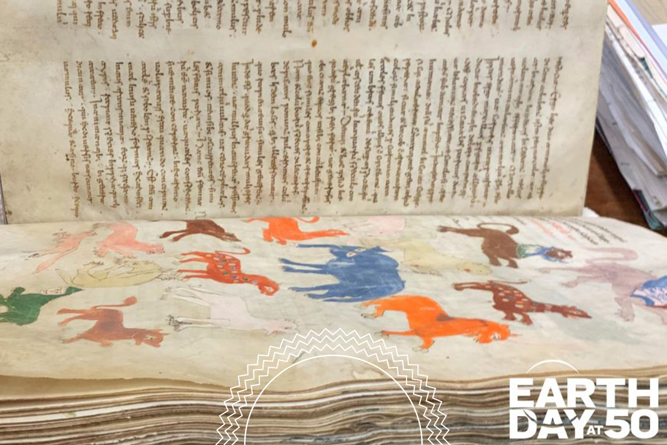 An old manuscript features a page of handwritten text above colorful animal illustrations, with an “Earth Day at 50” logo in the bottom right corner.