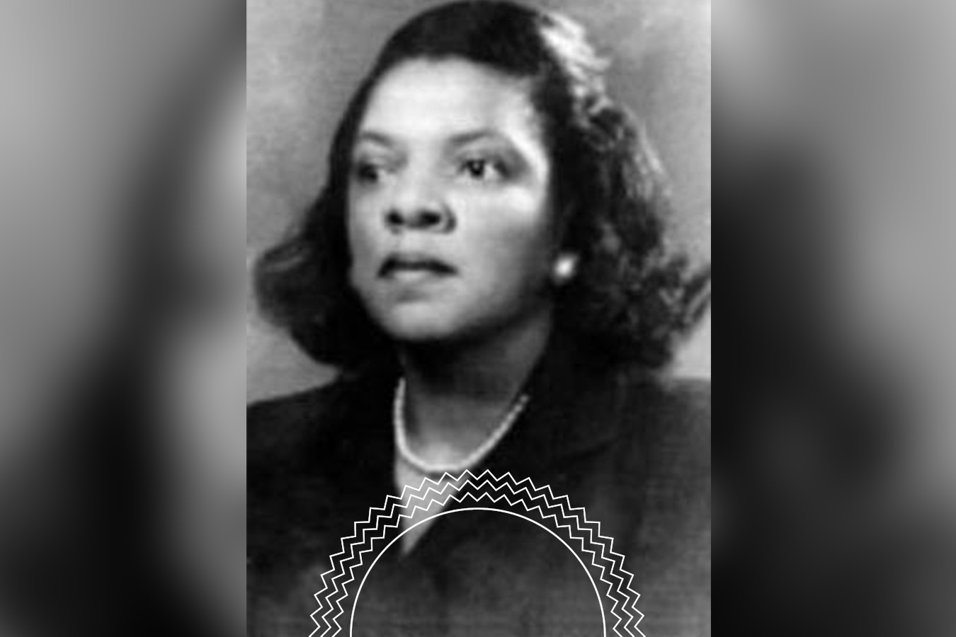 Black and white portrait of a woman with short, wavy hair, wearing a dark jacket and a light-colored necklace, facing forward with a neutral expression.