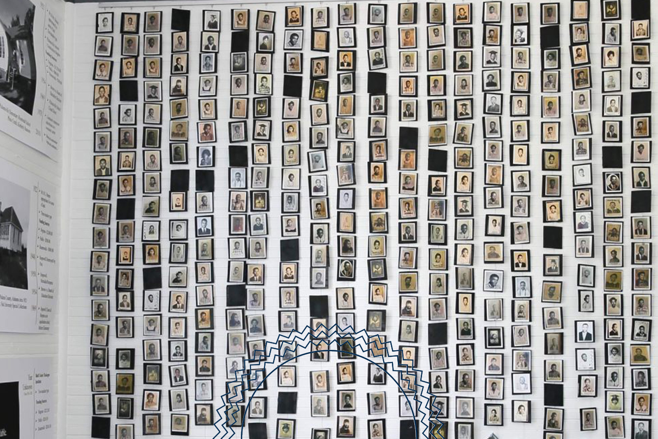 A wall covered with rows of small, framed portrait photographs, each depicting an individual, arranged in a grid-like pattern.