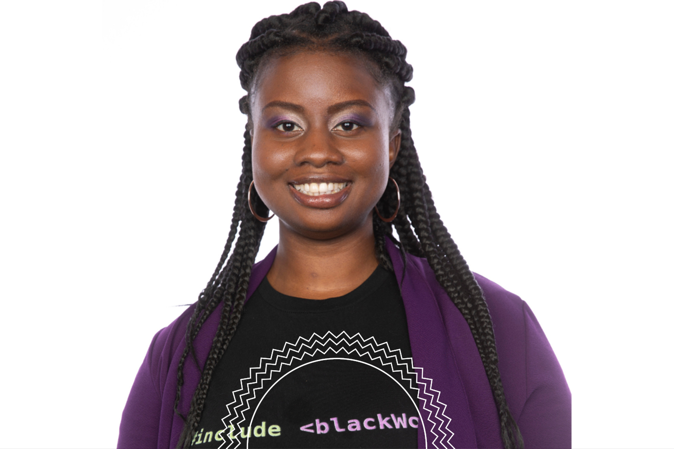 Woman with braided hair smiles at the camera, wearing a purple blazer and a black t-shirt with text and geometric graphics, against a white background.