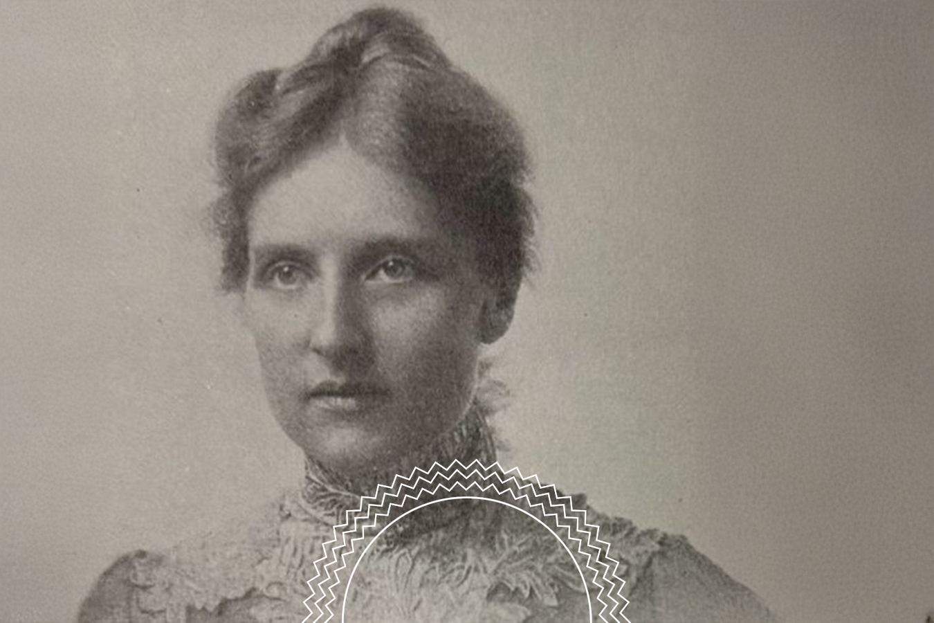 Black and white portrait of a woman with light hair in an updo, wearing a high-necked, detailed lace dress, facing the camera with a neutral expression.