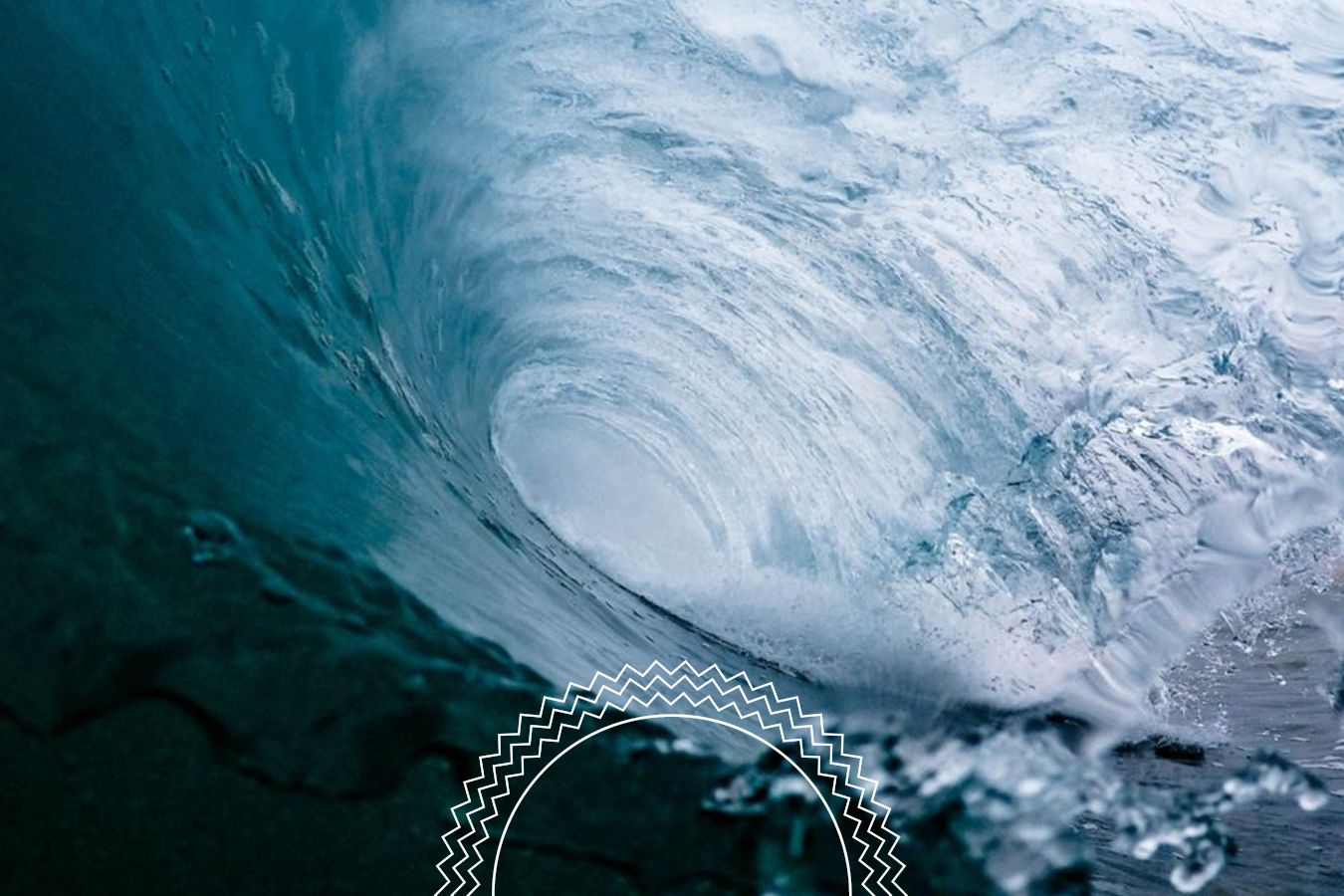 Underwater view of a powerful ocean wave forming a tunnel, with white foam and blue water swirling around the curved shape.