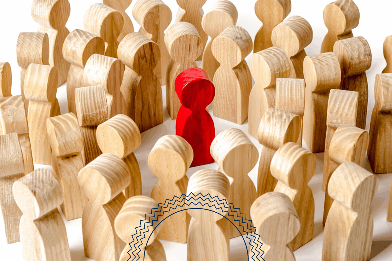 Many wooden figurines surround a single red wooden figure in the center, creating a scene of focus or isolation against a white background.