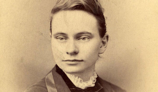Sepia-toned portrait of a young woman with light eyes, wearing a high-collared blouse and jacket, looking slightly to the side.